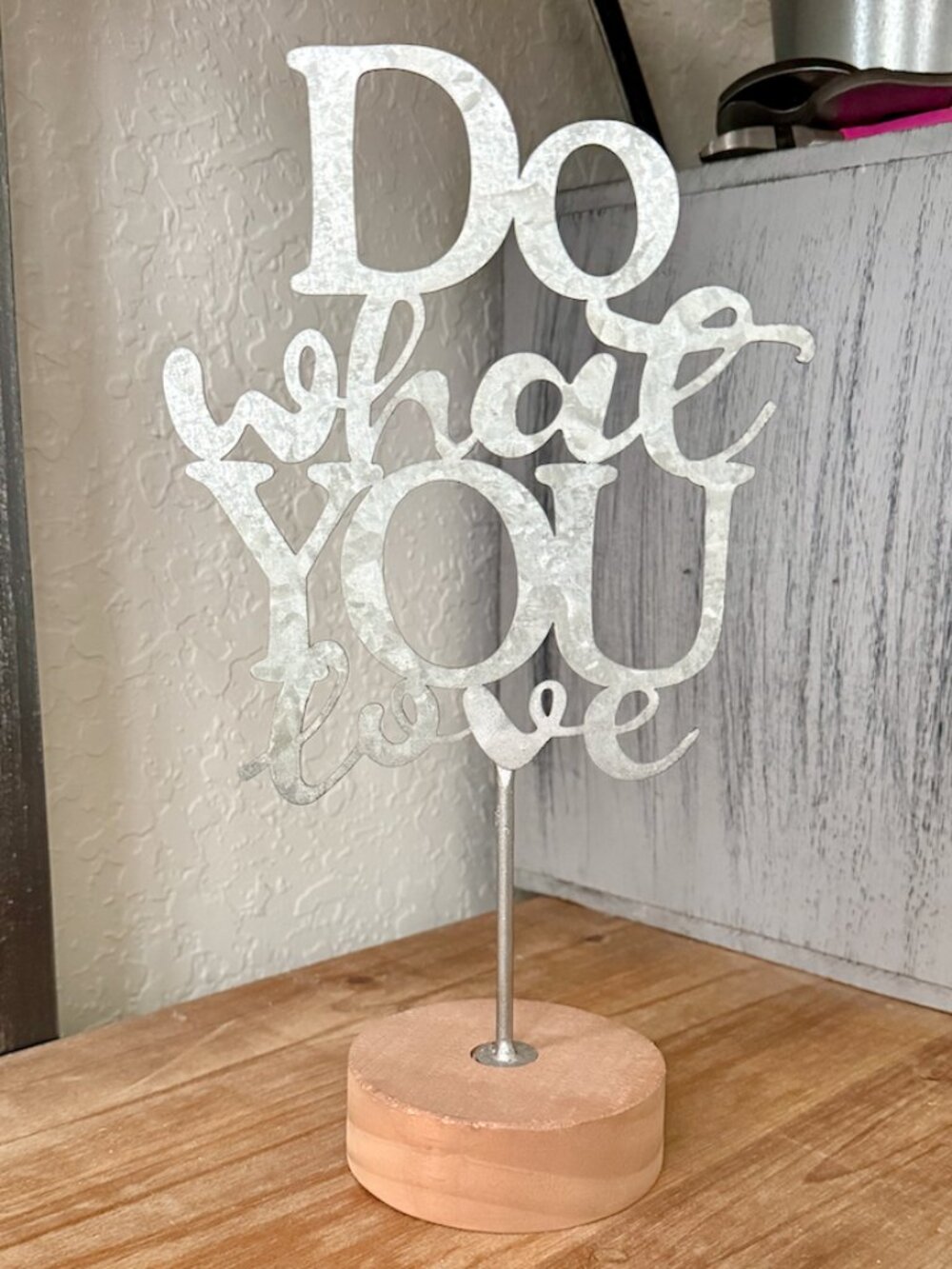 "Do What You Love" sign on a wooden base